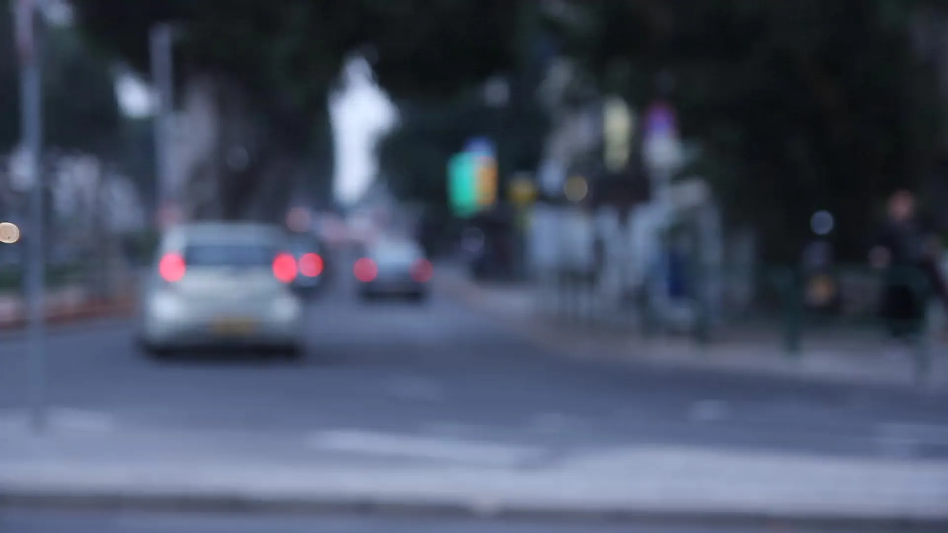 Blur blurry image of cars driving on a street Description automatically generated